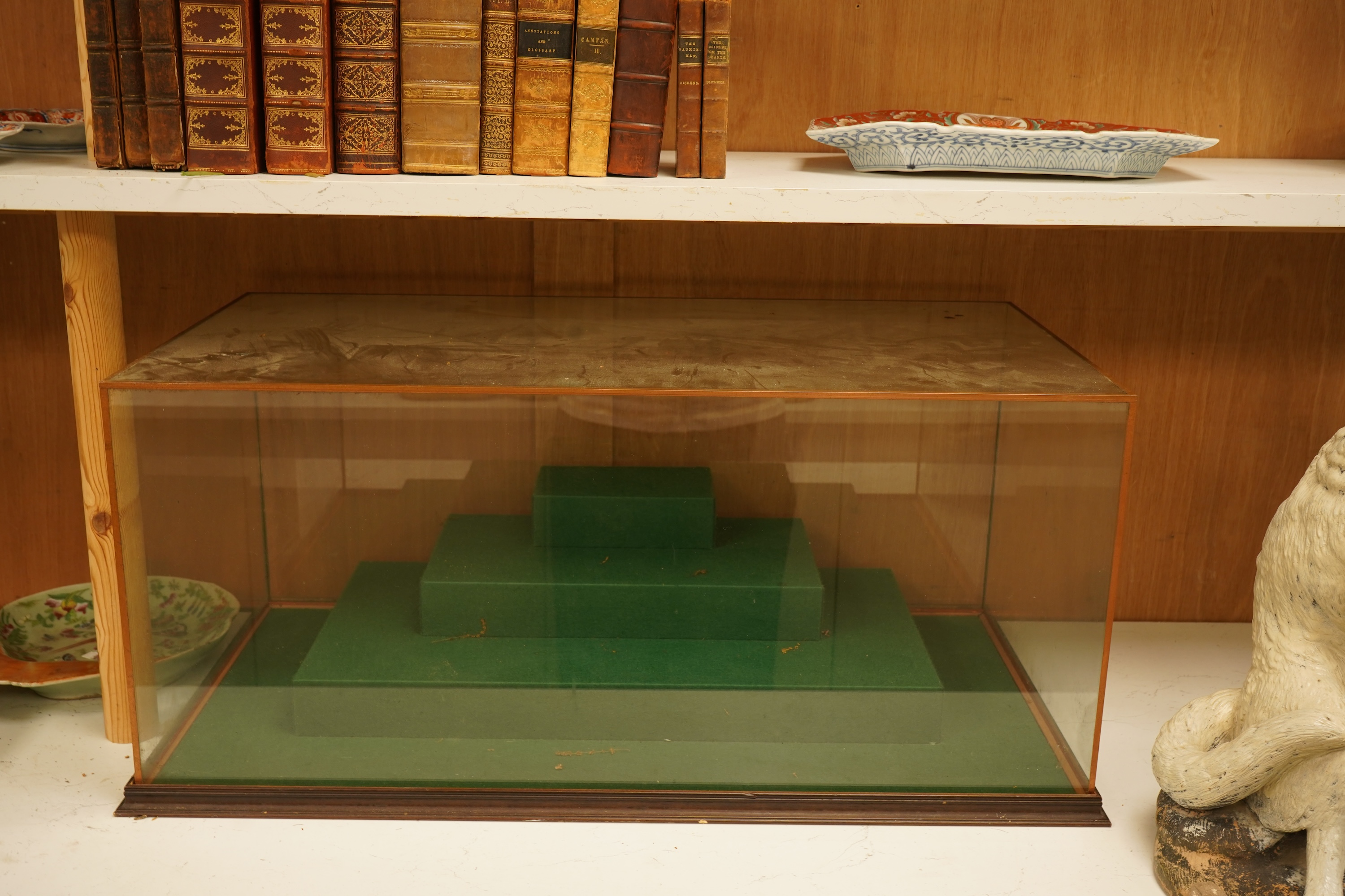 A large table top glass display cabinet with a stepped interior green baize base, 73.5cm wide x 33cm high x 39cm deep